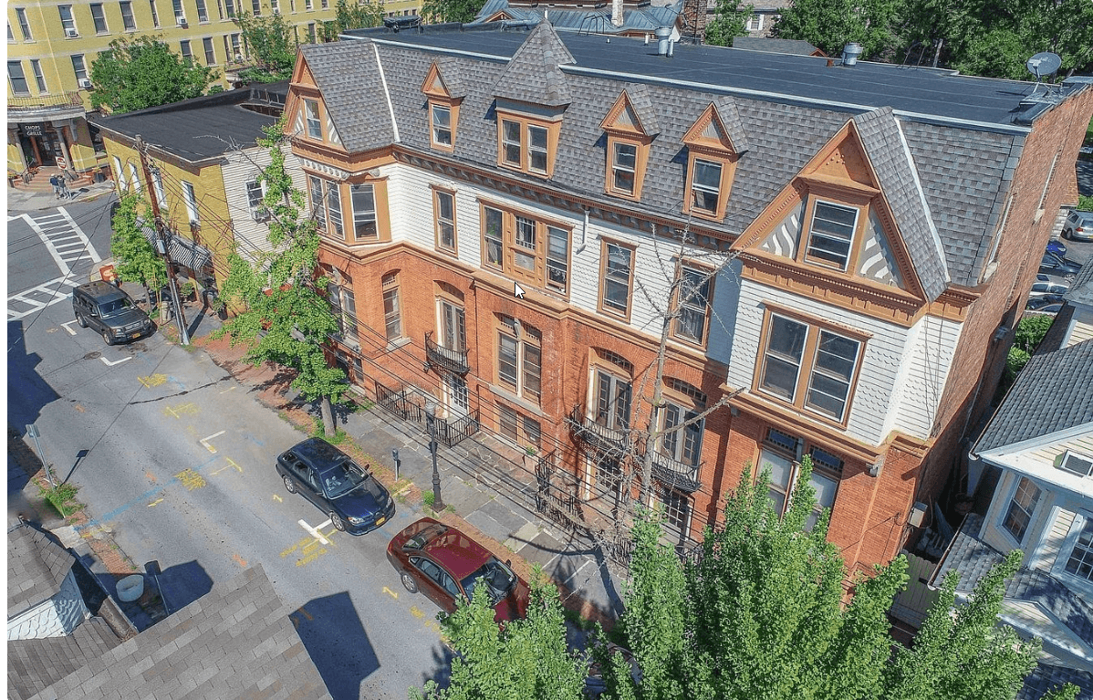an aerial view of a brick building on a city street