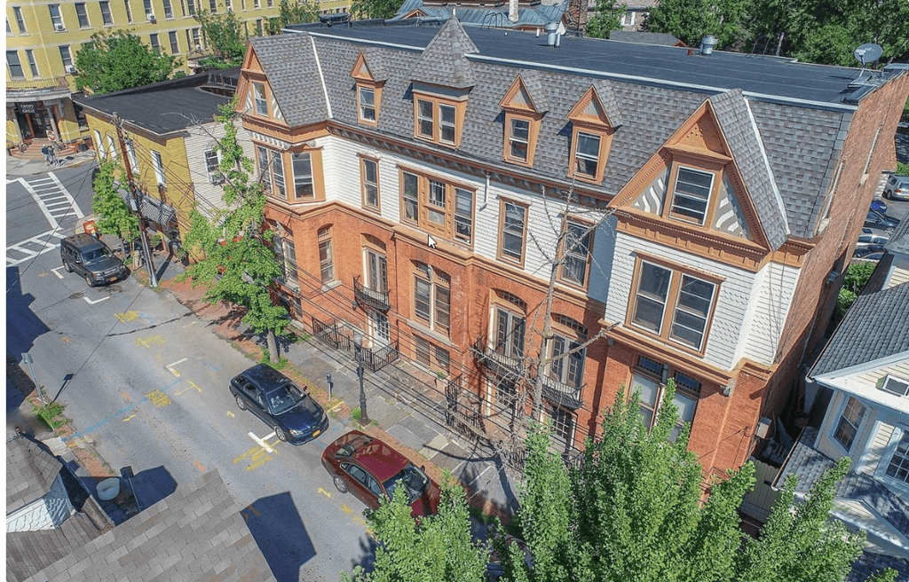 an aerial view of a brick building on a city street