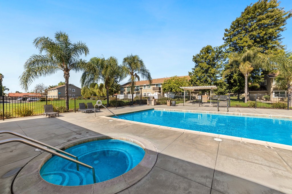 A swimming pool with a slide in the middle of it.