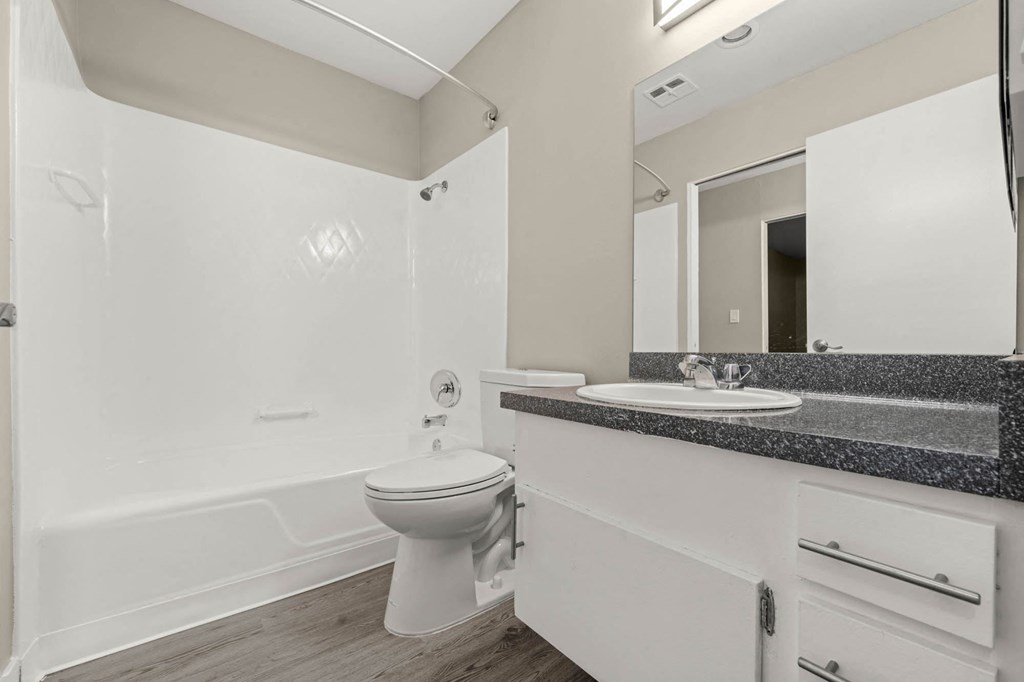 a bathroom with a toilet sink and bathtub