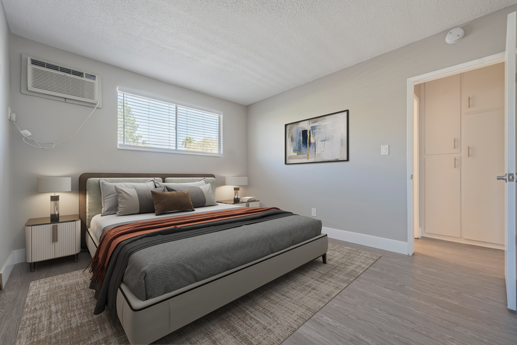 a bedroom with a bed and a door to a closet