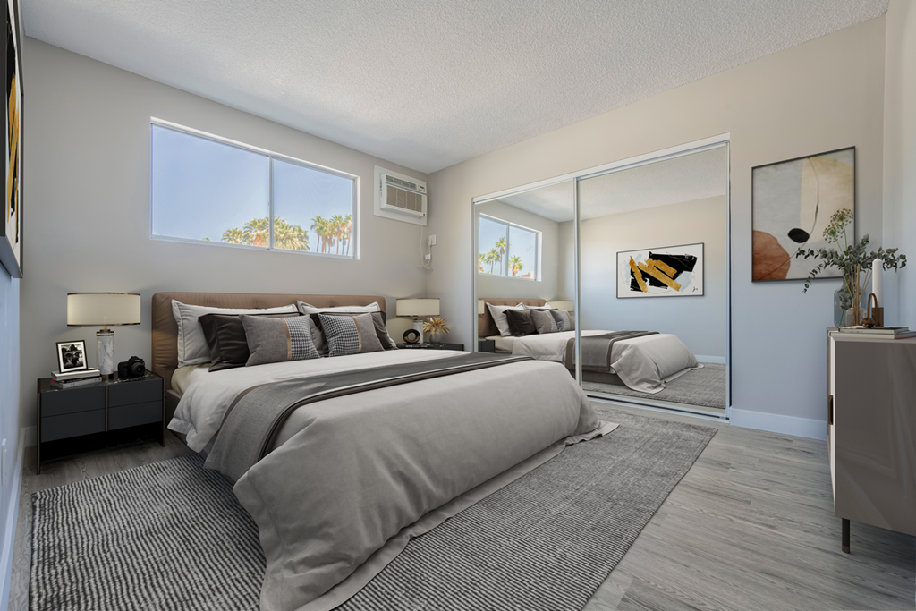 a bedroom with a large bed and a mirrored closet