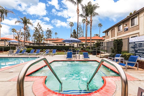 A pool and jacuzzi with a red and green design in the middle of it.
