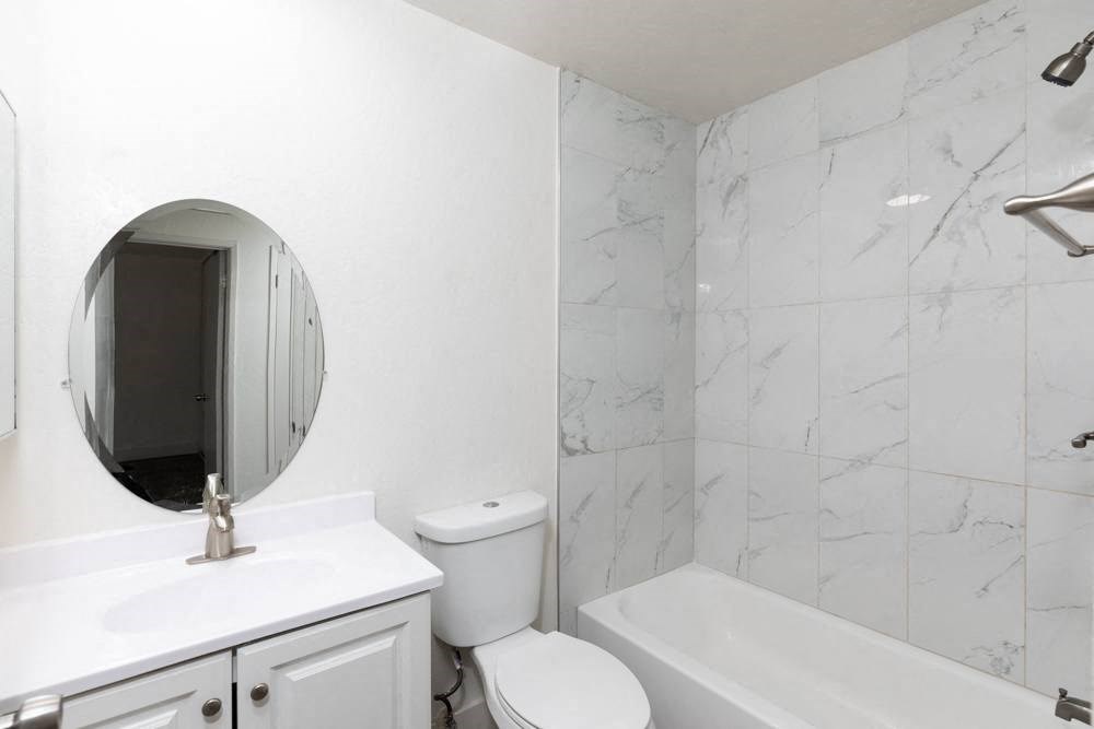 a bathroom with a sink toilet and a bath tub