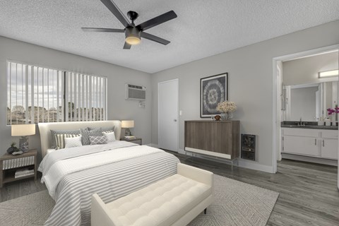 a bedroom with a large bed and a ceiling fan