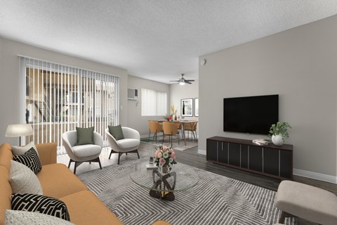 a living room with a couch and chairs and a tv