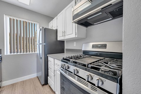 a kitchen with a stove and a refrigerator