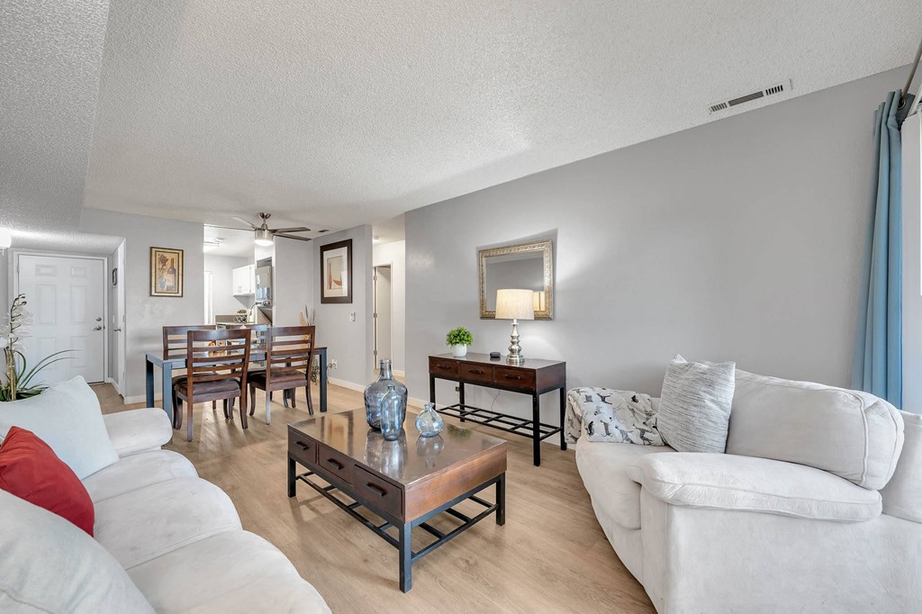 a living room and dining room with a couch and a table