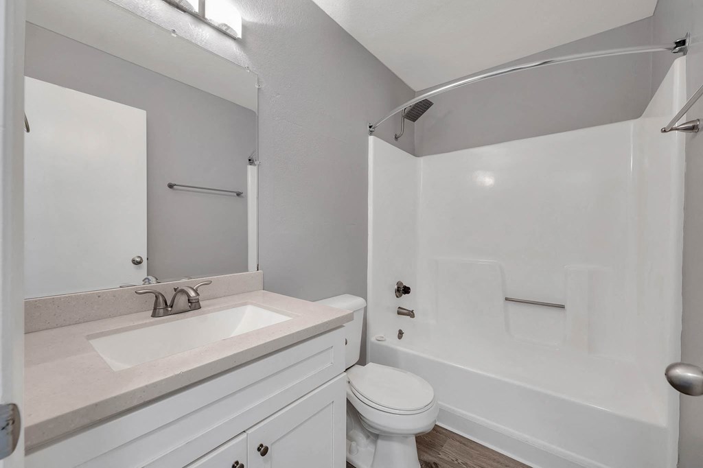 a white bathroom with a sink and a toilet