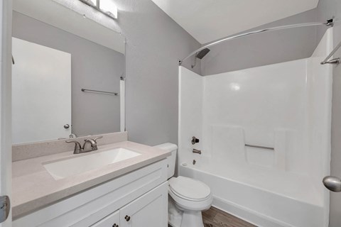 a white bathroom with a sink and a toilet