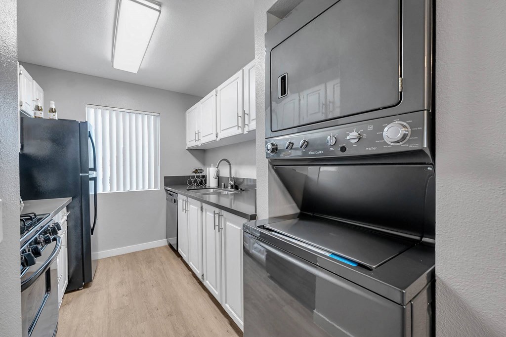 a kitchen with stainless steel appliances and white cabinets