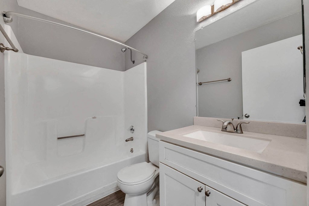a white bathroom with a sink and a toilet