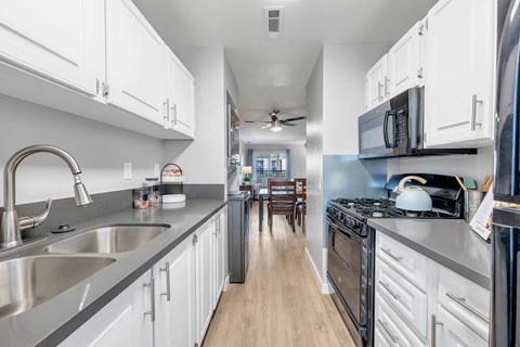 a kitchen with stainless steel appliances and white cabinets