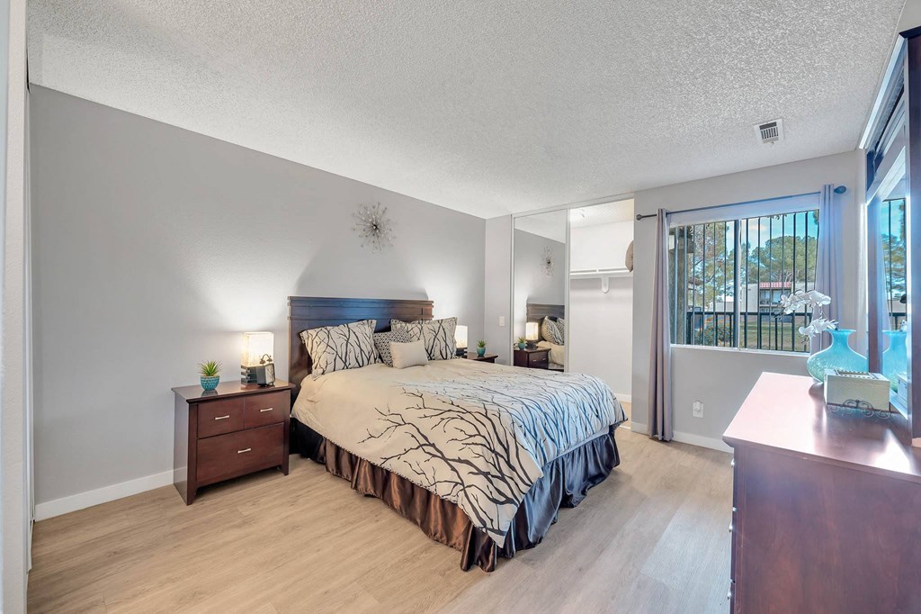 a bedroom with a bed and a sliding glass door