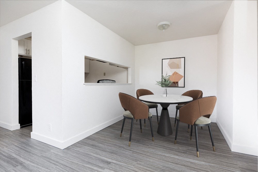 a dining room with a table and chairs and a mirror