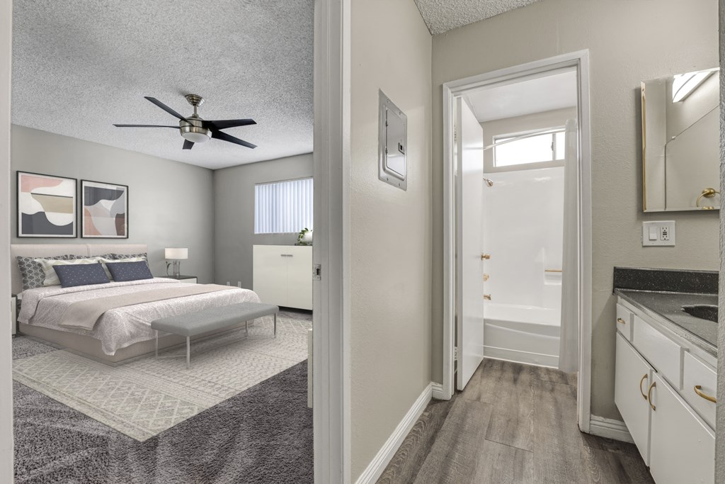 a bedroom and a bathroom with a ceiling fan