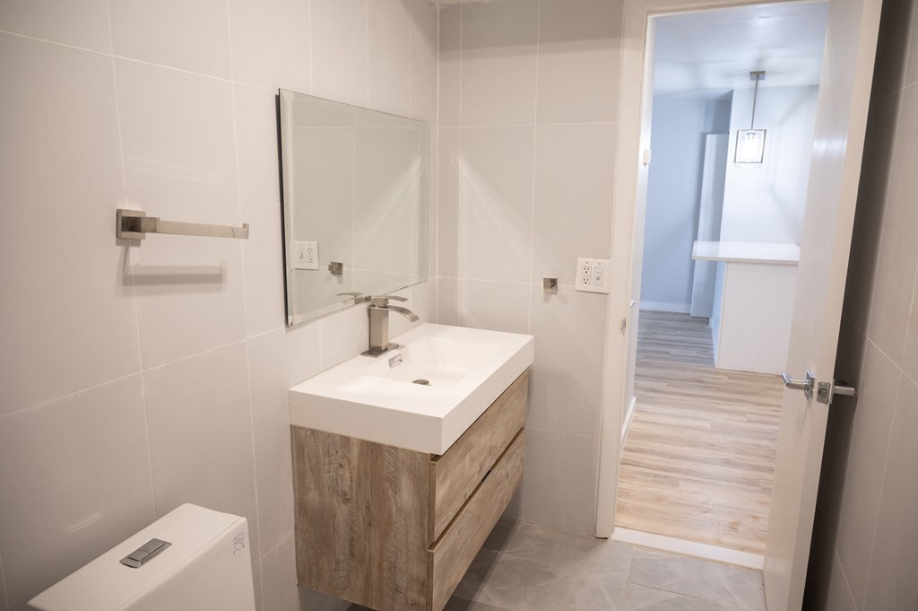 a small bathroom with a sink and a mirror