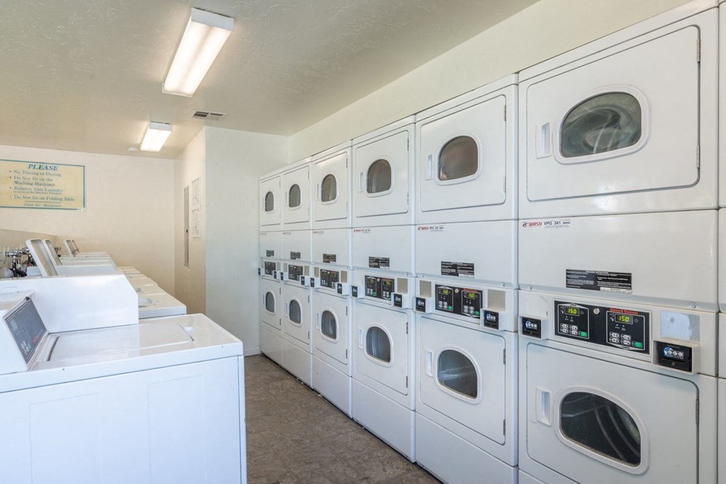 A row of washing machines in a laundromat.