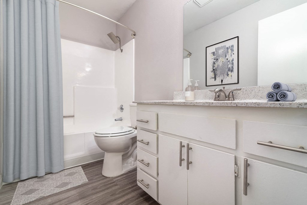 a bathroom with a toilet sink and shower