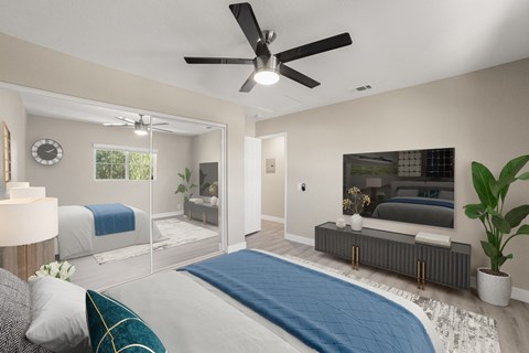 A bedroom with a bed, a ceiling fan, and a television.