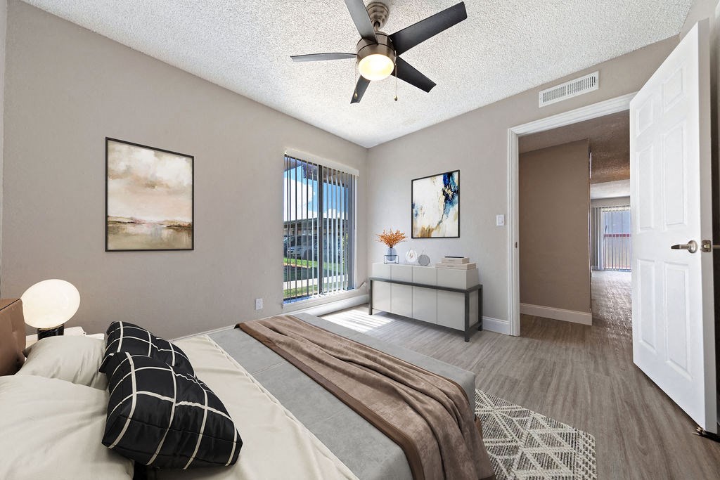 a bedroom with a large bed and a ceiling fan