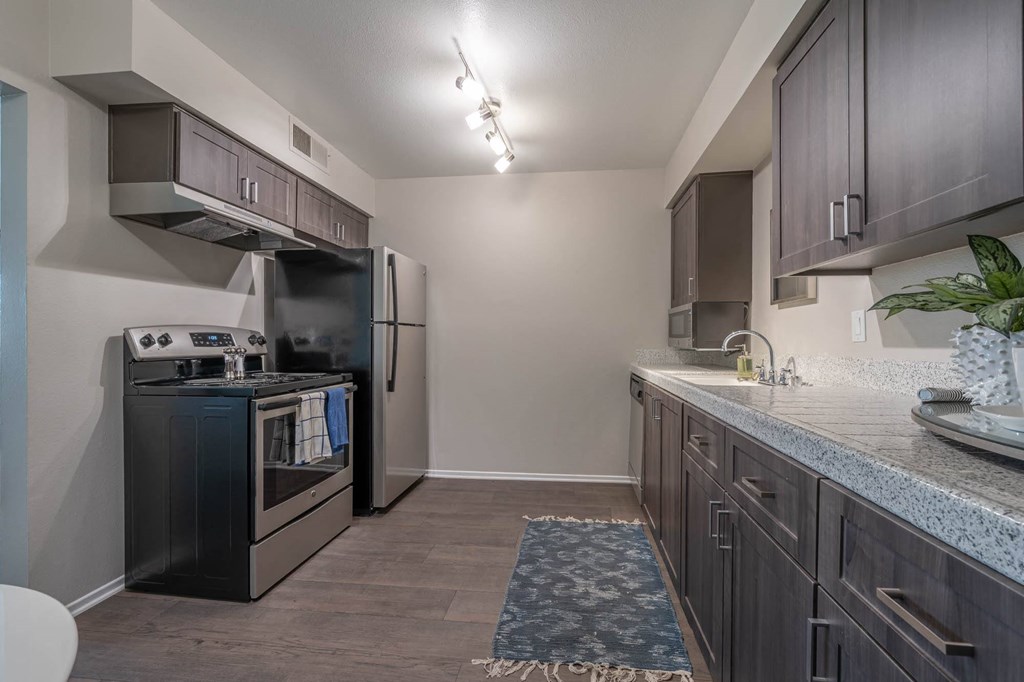a kitchen with stainless steel appliances and granite counter tops