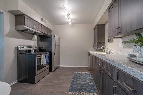 a kitchen with stainless steel appliances and granite counter tops
