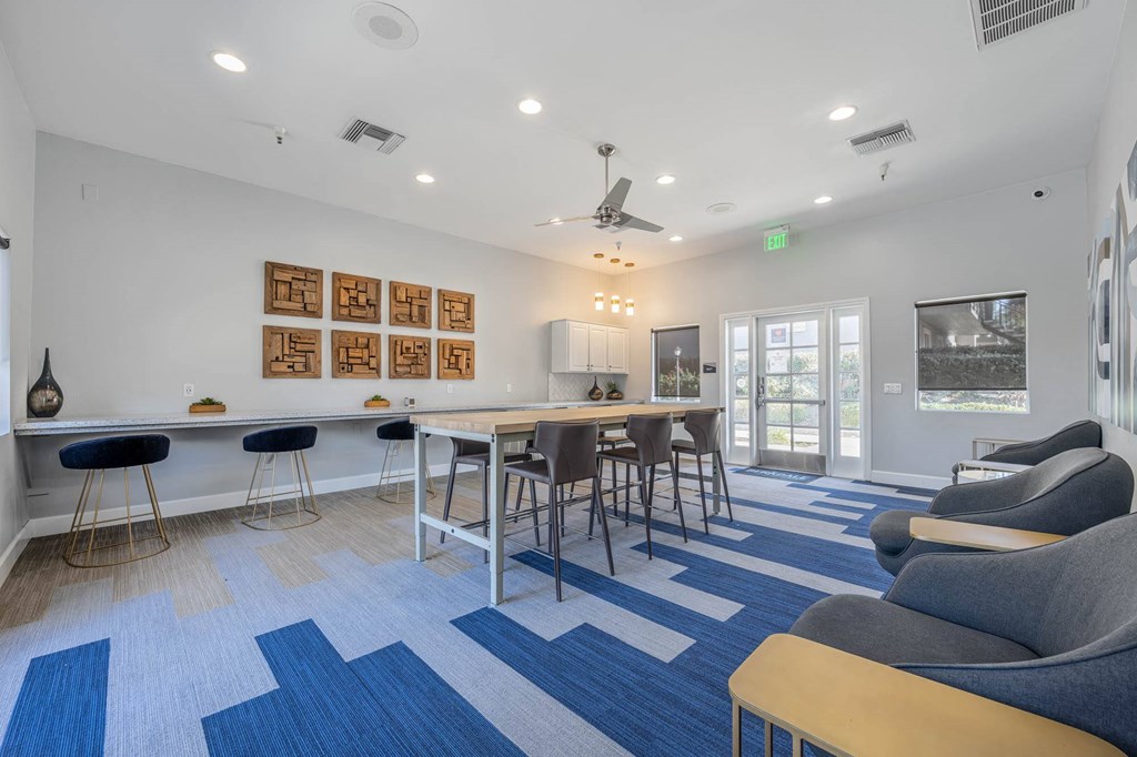 a living room with a bar and a dining table