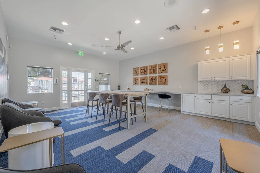 a living room with a dining room table and chairs