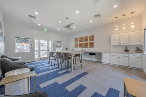 a living room with a dining room table and chairs