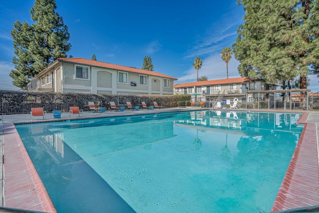 a swimming pool with a building in the background