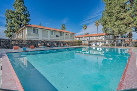a swimming pool with a building in the background