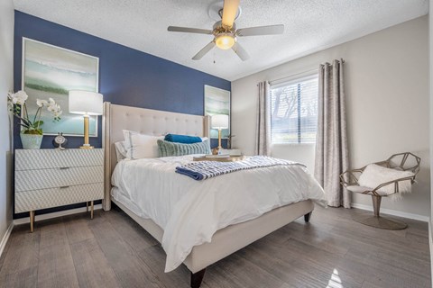 a bedroom with a bed and a ceiling fan