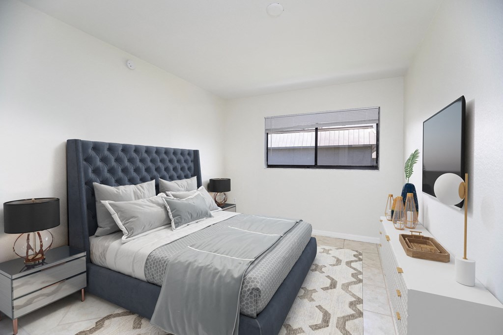 a bedroom with a large bed and a flat screen tv