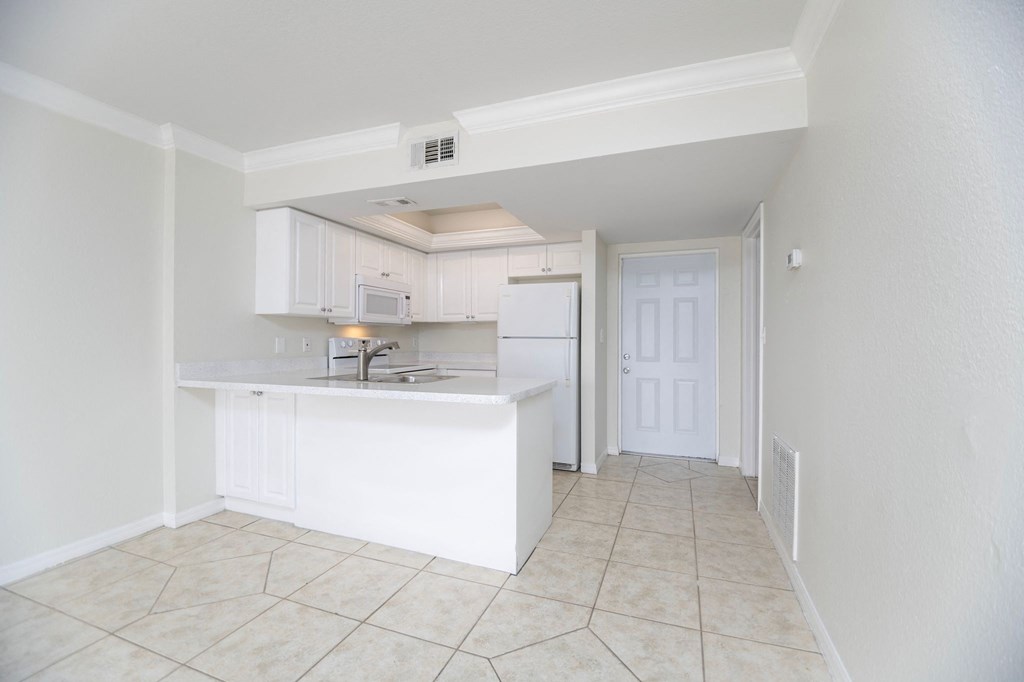 a kitchen with an island and white cabinets