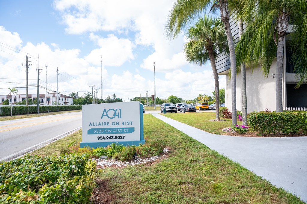 a building with a sign that says on the side of a road