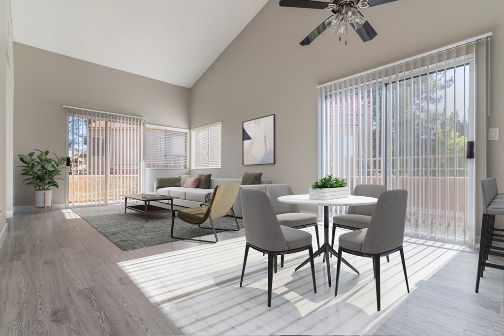 an open living room with a dining room table and chairs
