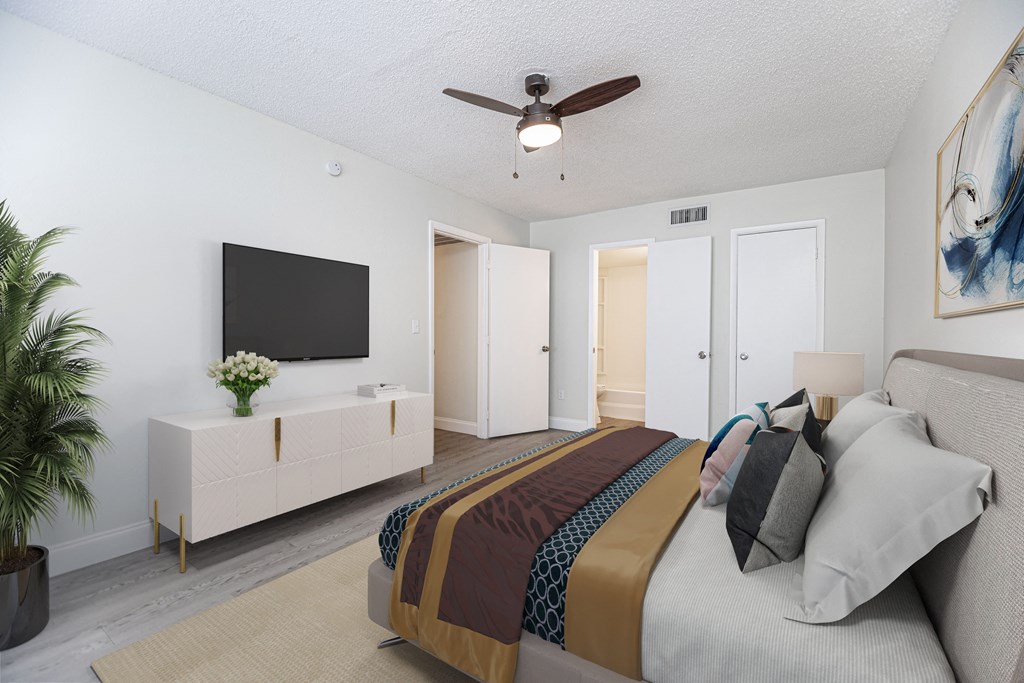 a bedroom with a large bed and a ceiling fan