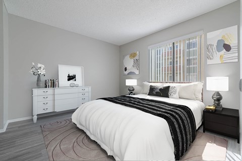 a bedroom with a large bed and a window