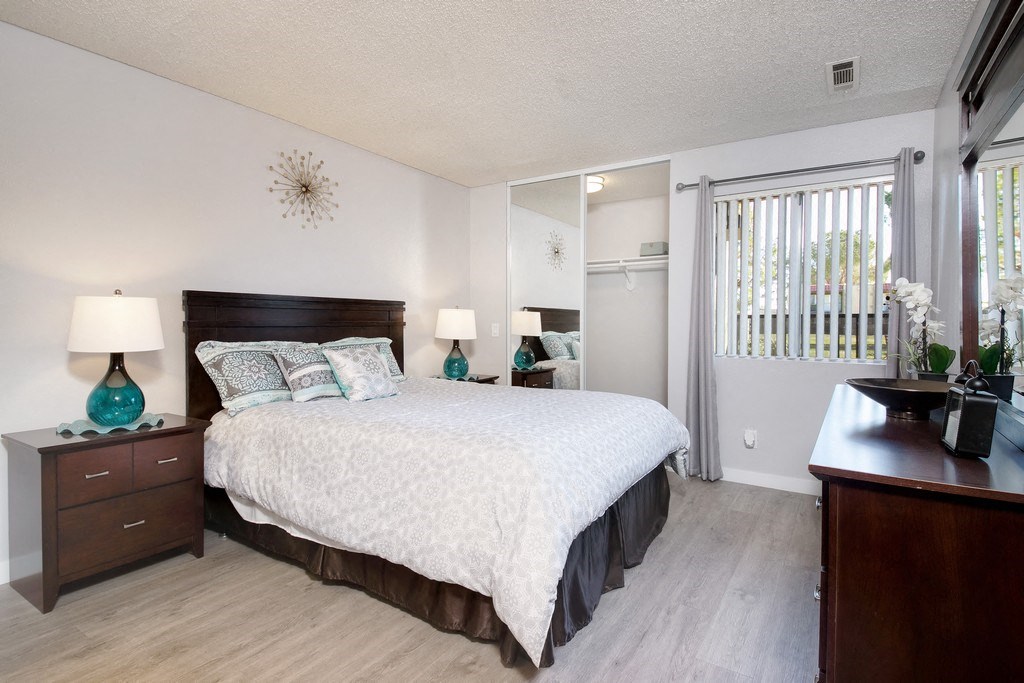 a bedroom with a large bed and a window