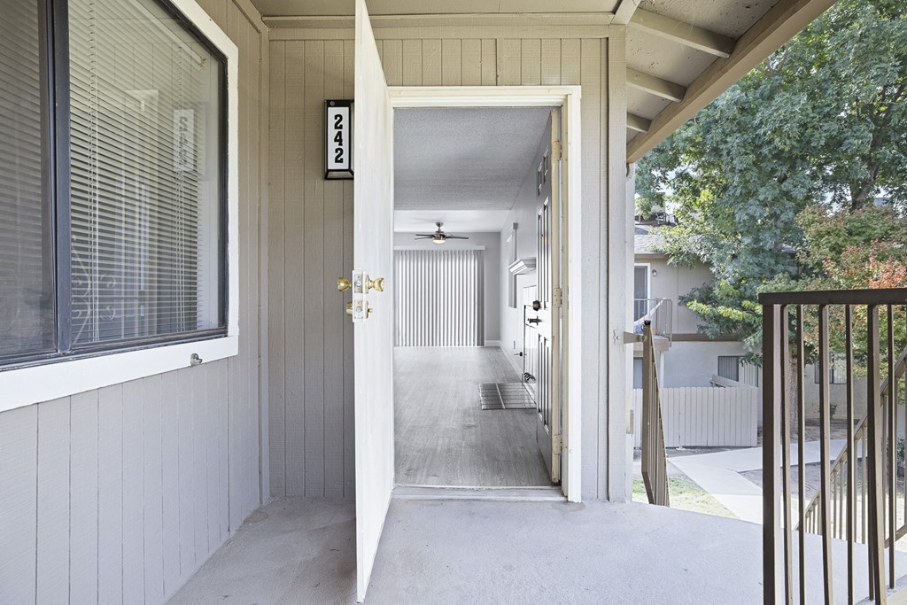 the front door of a home with a long porch