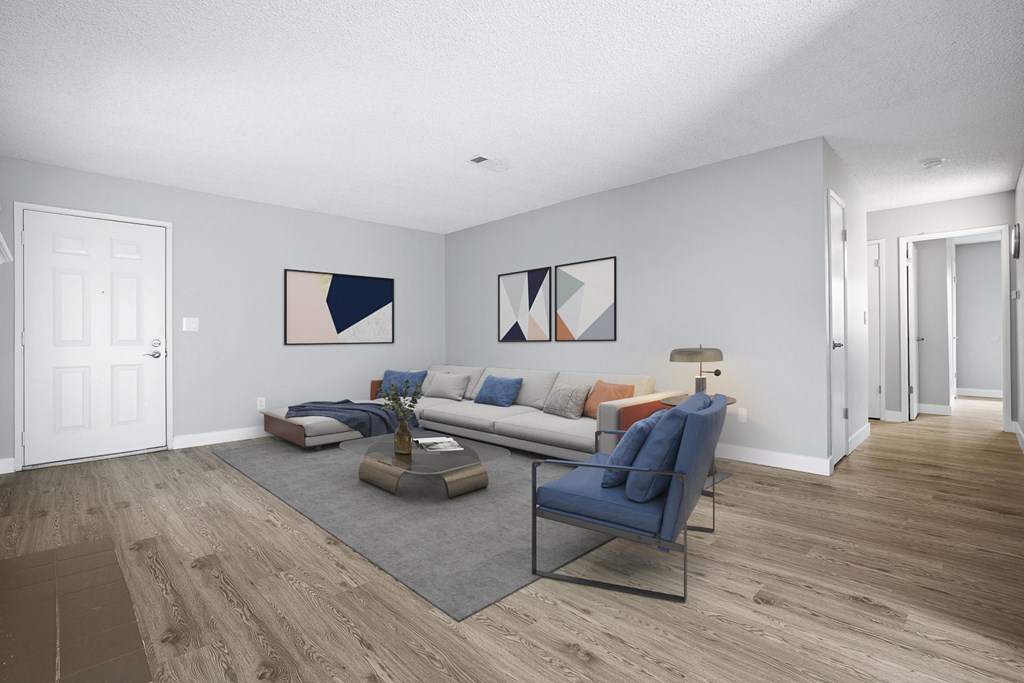 A living room with a blue couch and a coffee table.