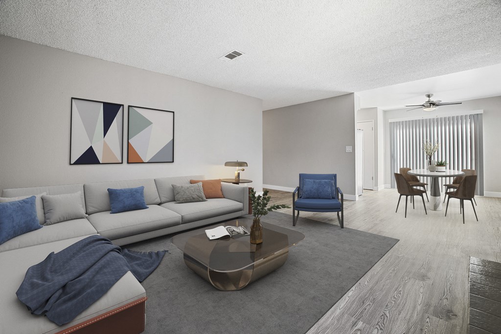 A living room with a grey sofa, a blue chair, and a coffee table.