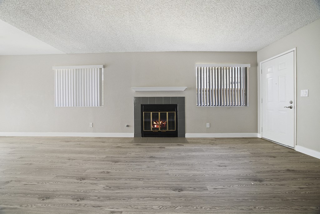 A room with a fireplace and a door.