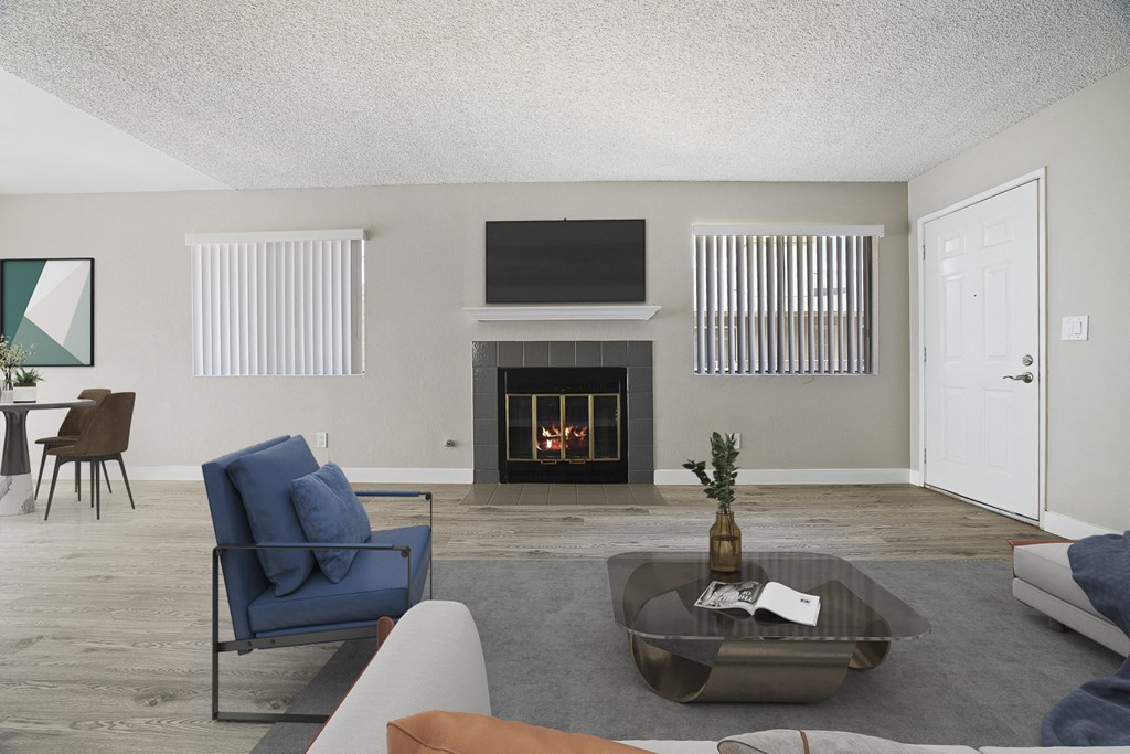 A living room with a fireplace and a television.
