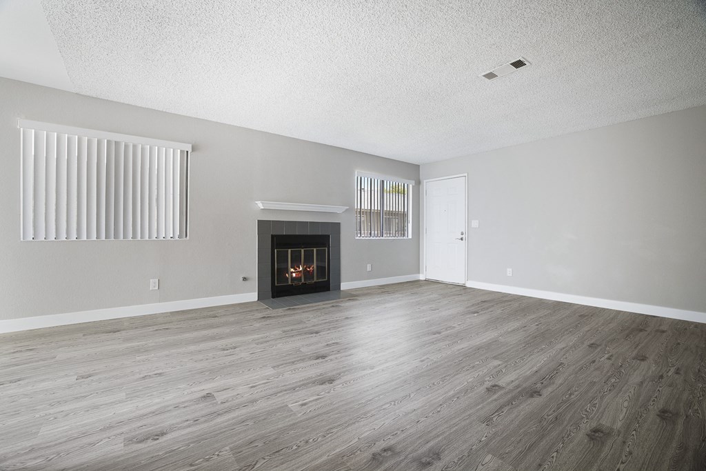 the living room of an empty house with a fireplace
