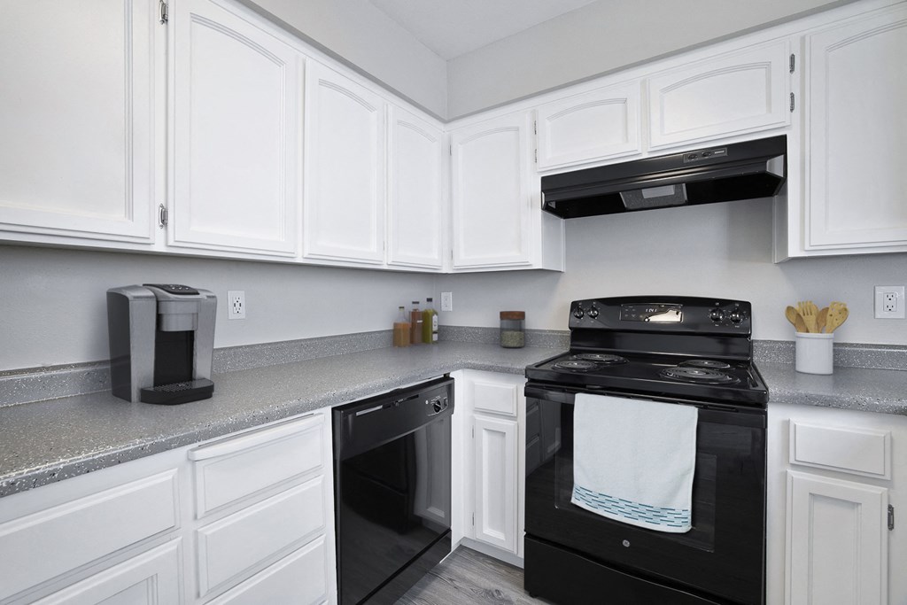 A black stove top oven with a white towel on it.