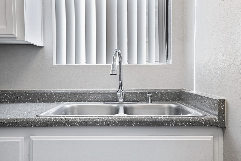 a kitchen sink with a window above it