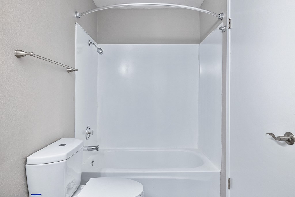 an empty bathroom with a toilet and a shower