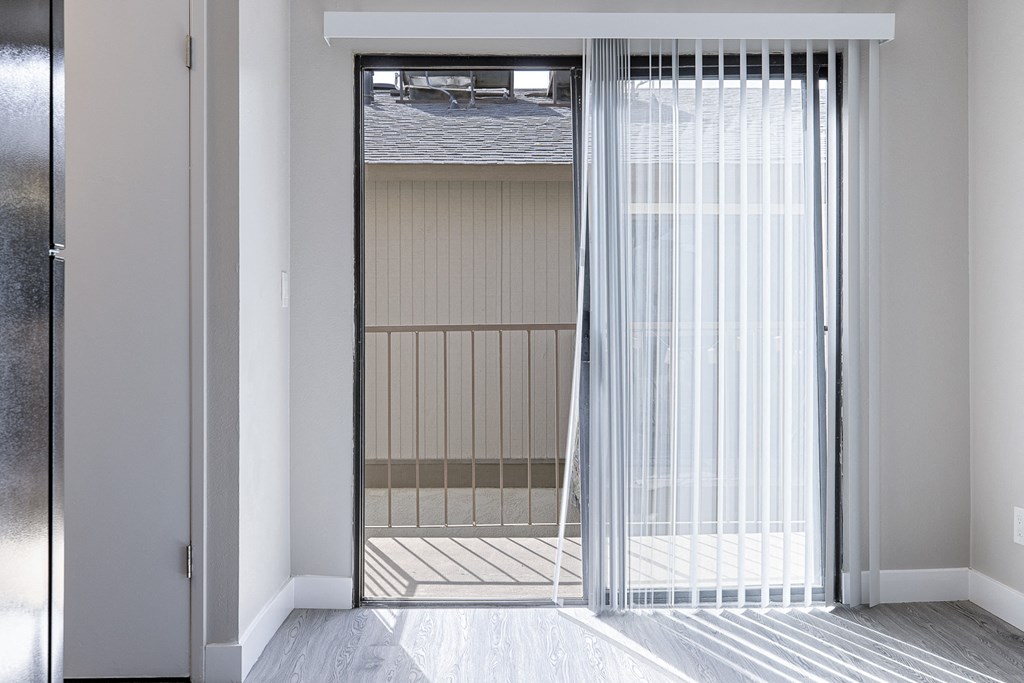 a sliding glass door leading to a prison cell